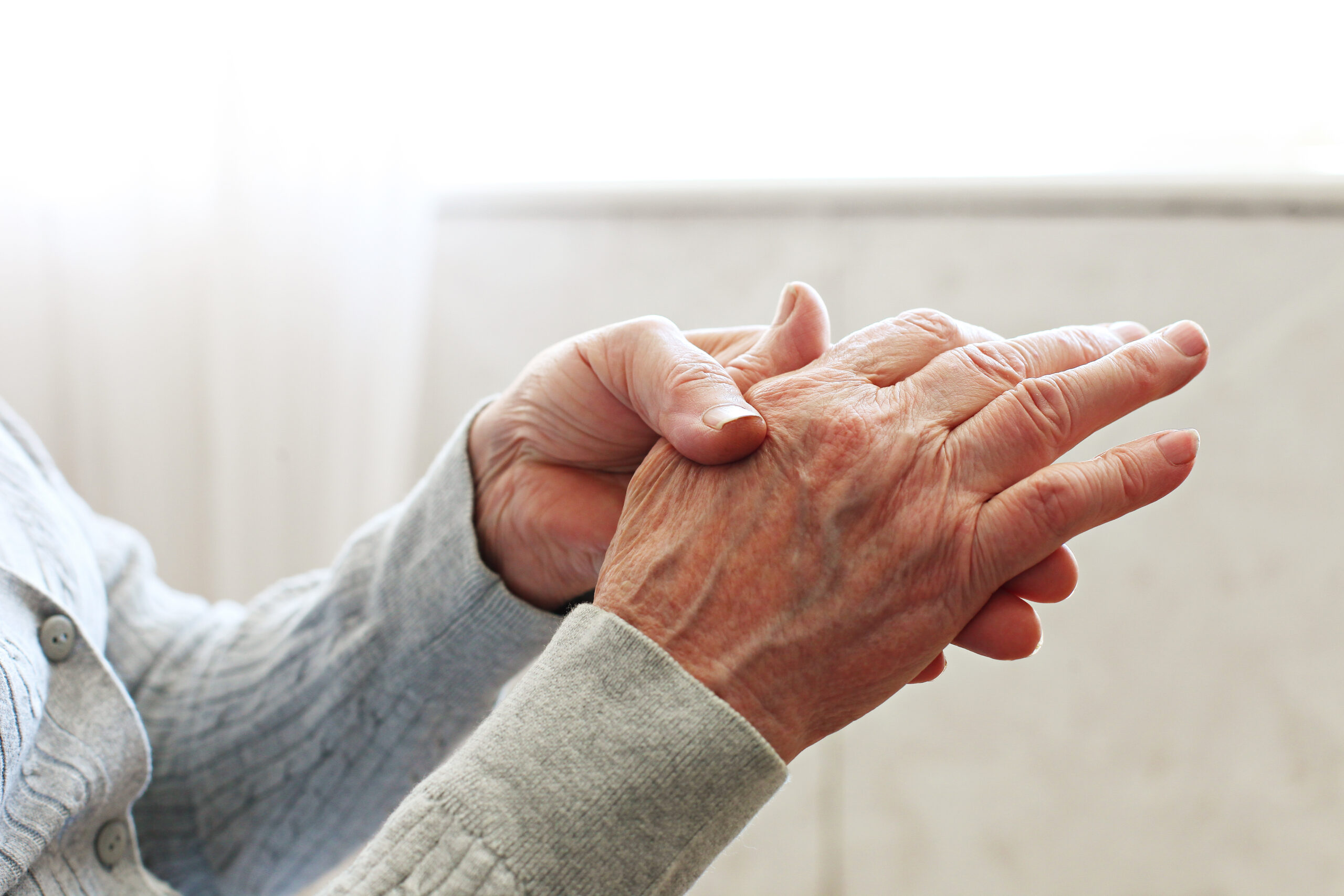 physical therapist assisting patient with joint mobility exercise for arthritis